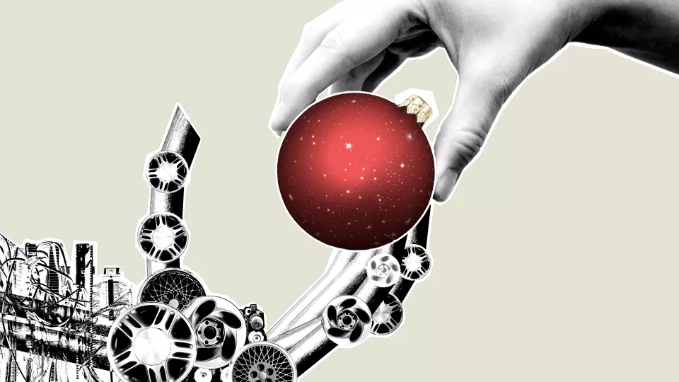 Picture. Human hand handing a Christmas ornament to a robot hand. 