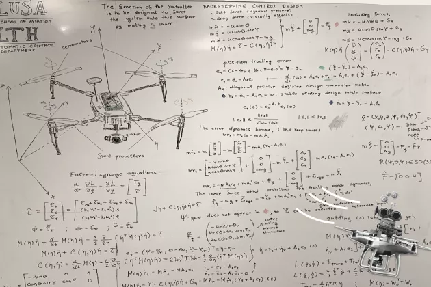 Illustration. Mathematical description on a white bord of the control system for an unmanned aerial vehicle.