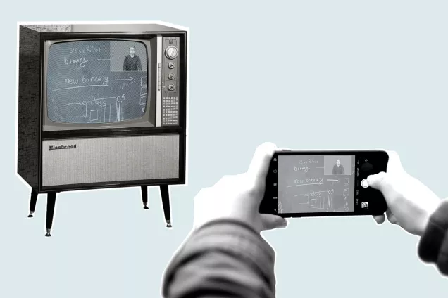 Picture of a person holding a mobile phone taking a picture of an old TV. Photo. 